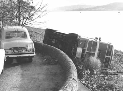Shandon Bus Crash
A Garelochhead Coach Service double decker bus lies on the beach at Shandon after an accident on the old lochside road in November 1965. Andrew Shirley from Rhu, who is researching the Garelochhead bus companies, believes this bus is MXX 177, one of the former London Transport RT class operated by the firm. It was repaired and put back into service.
