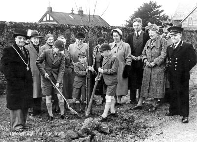 Coronation tree planting
One of many Coronation tree planting ceremonies in Helensburgh in 1953. This one was in Stafford Street at the back of the then Larchfield School and shows headmaster Stephen Hutchinson, fourth from right, and Burgh Officer Alexander Hailstones. Other names would be welcomed. At the back is the old 'tin hut' classroom building and part of the next door house, Inistore. Image supplied by Robert Hailstones, Alexander's son.
