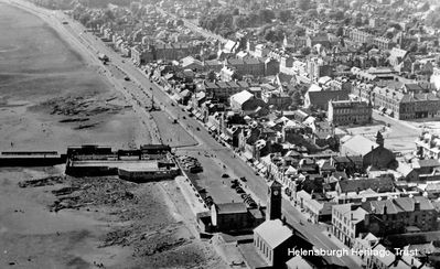 Aerial view to west
A view of the west side of Helensburgh town centre, including the Old Parish Church, the old Granary building at the foot of Sinclair Street, the outdoor swimming pool, and the Tower Cinema and Pender's Garage in Colquhoun Square â€” all now demolished. Image date unknown.

