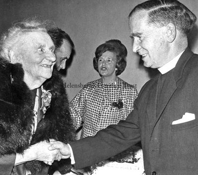 St Bride's Centenary
Miss Annie Baird, then 83, sister of John Logie Baird and daughter of the Rev John Baird, is greeted by the St Bride's Church minister, the Rev Robert S.Cairns, who invited her to cut the cake at the Church's Centenary Supper in the Victoria Hall in 1967. In the background is Mrs Arthur Wylie, one of the organisers of the event.
