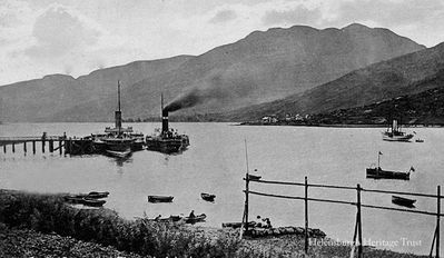 Arrochar Pier and Loch Long
Two steamers are berthed at Arrochar Pier, which was built in 1850 and used to service several steamers daily with visitors from Glasgow. On the other side of the loch is the torpedo testing station. Image circa 1920.
