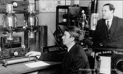 Television transmitter
John Logie Baird at the transmitter of his experimental radio station G2KZ from which television was transmitted across the Atlantic in February 1928. Looking on is his technical assistant, Ben Clapp.
