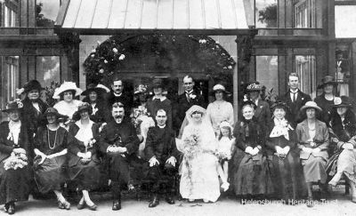 Wedding guest
John Logie Baird (2nd from right, back row), his father, the Rev John Baird (4th from left, front row), and his mother Jessie, a niece of the famous Inglis shipbuilding brothers Anthony and John, are seen in this wedding group outside the Queen's Hotel in Helensburgh on June 6 1922. The bride was JLB's sister Jeannie, known to friends as Tottie, and the groom is the Rev Neil Conley. Jessie Baird is on the bride's left, and JLB's sister Annie is immediately behind the groom. Far left back row is Anna Snodgrass (nee Inglis), aunt of Arnold Snodgrass. JLB is looking fit after a sojourn at a health spa. The Conleys' son Norman (b.1926) moved from Glasgow to Helensburgh about 2002 and passed away early in 2009. Norman's daughter Laura Conley (b.1954) is still living in the burgh.
