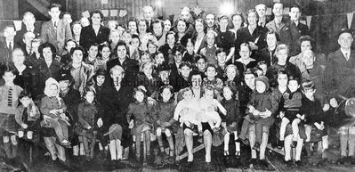 British Legion
Little is known of this picture of a British Legion function in the now demolished Drill Hall in East Princes Street, Helensburgh. A mother holds twins at the front, and there appears to be a Christmas tree at the back. The editor would welcome any more information â€” please use the Contact Us facility on the Trust website homepage. Image supplied by Rae Simon.
