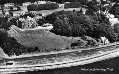 Cairndhu and Ferniegair
Two of Helensburgh's biggest mansions, Cairndhu and, on the right, Fergiegair â€” home of the Kidston family and demolished in the 1960s. Cairndhu was built in 1871 by architect William Leiper for John Ure, then Provost of Glasgow, and Ferniegair was built in 1869 by architect John Honeyman. Behind is Ardencaple Quadrant, built originally to house those who had been injured in the First World War. Image circa 1960.
