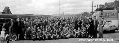 RAF squadron visit
A previously unpublished picture from a fighter pilot's scrapbook of members of the RAF's 610 Squadron on summer visit to Helensburgh from their base in Cheshire in 1938. They have donned tartan berets, much to the amusement of local children. The following year war broke out and two years later these men were fighting in the Battle of Britain and Helensburgh had its own RAF station. Image supplied by Robin Bird.
