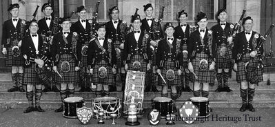 Clan Colquhoun Pipe Band
The Helensburgh-based Clan Colquhoun Pipe Band outside Clyde Street School in 1952. Back: Jimmy Simpson, Ian Laurie, Dougie Martin, Tommy Williams, Malcolm Gilmour, Mick Thrule, Jimmy Martin; front: Pipe Major Archie McNicol, John Cameron, Robert Toole, Andy Clark, Tom McDougall, Jim Gunn. Two members missing from the picture were A.McLean and John Boyle.
