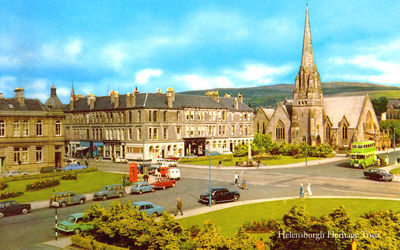 Colquhoun Square
A green Garelochhead Coach Services bus is at the bus stop on a sunny morning in Helensburgh's Colquhoun Square. Image circa 1970.
