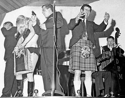 Explosive opening
Sir Hugh Fraser shocked all on stage when he fired a starting pistol to signal the opening of the Duck Bay Marina business started by his friend Bobby Cawley in April 1968. Beside Sir Hugh is famous local Highland Games athlete Jay Scott.
