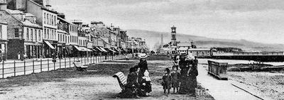 Family on West Bay
Adults and children are seen in this early 1900s image of Helensburgh's West Esplanade, looking east towards the Old Parish Church from John Street. Image date unknown.
