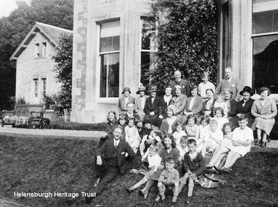 Sunday School picnic
Adults and children attend a Sunday School picnic at Finnart House on Loch Longside, circa 1932. It was then the home of Dr Harry Miller, a past Moderator of the Church of Scotland, who is in the back row to the right.  One of his five daughters is next to him. In the row of ladies in front of the back row, 6th from left is Jean Bolton and 8th from left is Mary Rae.  Image from the collection of Stella Trainor, Ontario, Canada.
