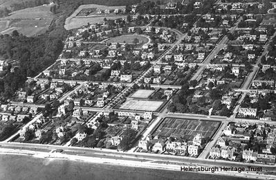 Helensburgh West
An aerial view of west Helensburgh, showing Helensburgh Lawn Tennis Club in the days of its original wooden pavilions, and the Helensburgh Football Club pitch at Ardencaple. The image, date unknown, is from the collection of William Orr of Rhu, who was at one time the Burgh Engineer before becoming the Assistant Engineer for Argyllshire, and it was supplied by his great nephew, Alistair Quinlan.
