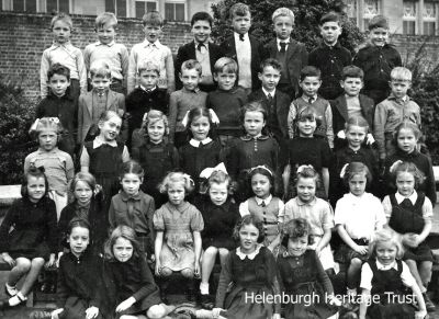 Hermitage c.1945
A Hermitage Primary School class from around 1945. Back row from left: Andy Wiseman, ?, Jim Aitken, Arthur Thomson, ?, Gordon Peebles, ?, Â ?. 2nd back row: Billy Campbell, Walter Marshal, Ian Smith, Jim Steel, George Douglas, Cosmo Fraser, ?, Gordon Fraser, Sandy Peters. 3rd row from back: ?,Â  Isobel Thornton, ?, ?, Mary Howie, Â Rita Todd, ?, ?. 4th row from back: Francis Black, ?, Margaret Lyon, ?, ?, ?, ?, ?,Â Irene Armstrong. Front row: ?, ?, ?, ?,Â Sheila Morton. Other names would be welcomed. Image supplied by Gordon Fraser.
