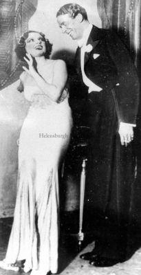 Jack Buchanan
Helensburgh-born Jack Buchanan (1891-1957), a major UK musical comedy, revue and film star, choreographer, director, producer and manager, was much associated with top hats and tails. The name of the actress in this picture is not known.
