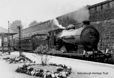 LNER train at Helensburgh Upper
A LNER passenger train on the West Highland Line waits at Helensburgh Upper Station before completing its journey to Glasgow. The engine's number is 221 and its name was Glen Orchy. It had a 4-4-0 arrangement. Image circa 1928.
