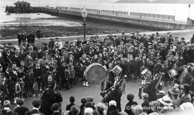 Beat Retreat
A large crowd on Helensburgh seafront listen to a pipe band beating the retreat. Image, date unknown, supplied by Malcolm LeMay.
