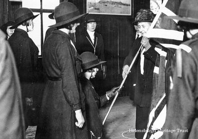 Royal Guide Colours
HRH Princess Louise, the Dowager Duchess of Argyll, who lived the later years of her life in Rosneath Castle, presents new colours to the 1st Rosneath Peninsula Girl Guides in 1928. On another occasion she presented the Union Flag to the 1st Cove and Kilcreggan Guides, and it is the oldest in the County of Dunbartonshire and still used in parades. She is also believed to have presented Campbell neckties to the Guides. Image by courtesy of Rosneath Castle Caravan Park.
