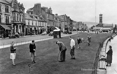 Seafront putting green
Spectators stop to watch keen competition on the Helensburgh seafront putting green, beside West Clyde Street, in the 1950s.
