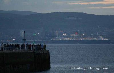 Queen Mary 2
The Queen Mary 2 â€” Cunard flagship and the longest, widest and tallest passenger ship ever built when she was launched in France in 2003 â€” was pictured from Helensburgh seafront at 5.07 p.m. in October 2009 by burgh man Iain Duncan. The liner berthed at Greenock on a tour of the UK to mark her fifth birthday. She can take 2,620 passengers and has 1,253 officers and crew, and has 15 restaurants and bars, five swimming pools, a casino, ballroom, theatre, planetarium, and kennels for passengers cats and dogs.
