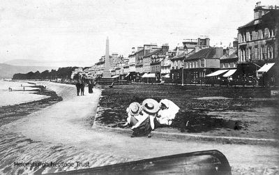Relaxing on seafront
A 1912 image showing two ladies with hats relaxing on the west esplanade near the pier.
