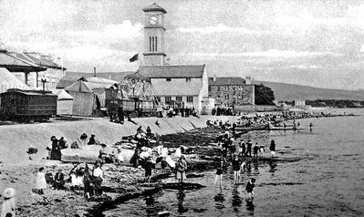 Seafront shows
Shows on Helensburgh seafront between the bandstand and the Granary on a summer day as youngsters paddle in the Clyde. Image circa 1906.
