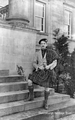 Sir Iain Colquhoun of Luss
Sir Iain Colquhoun DSO (1887-1948), 7th Baronet of Luss, Chief of Clan Colquhoun, and Lord Lieutenant of Dunbartonshire, was pictured on the steps of the family home, Rossdhu, Luss â€” now the exclusive Loch Lomond Golf Club â€” by Robert Thorburn, a keen amateur photographer and grocery store manager who moved to the burgh before 1900. He lived in Helensburgh until his death in 1945. Image circa 1920s supplied by his grandson, Sandy Thorburn.

