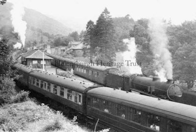 Trains at Ardui
Two steam trains on the West Highland Line at Ardlui Station, Loch Lomond, on August 13 1959. The engine which can be seen pulling a Glasgow train, no.61342, is a 71-ton Class B1 locomotive. Designed by Thompson, the class was introduced in 1942, and 409 were built.
