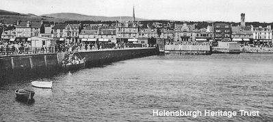 View from pier
Looking ashore from Helensburgh pier, with passengers boarding a boat at the pier steps. Image date unknown.
