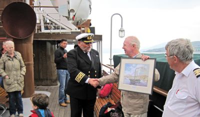 Print presented
Comet bicentenary committee and Helensburgh Heritage Trust chairman Stewart Noble presents a signed and framed print of Neil MacLeod's painting of the Comet replica to the captain of the world's last sea-going paddle steamer PS 'Waverley to mark the bicentenary in July 2012. Photo by Judy Noble.
