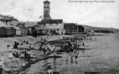 Pier View
Looking east from Helensburgh pier, with paddling where the pier car park is now. A funfair on the left and the old Granary can be seen in front of the clock tower. Undated.
