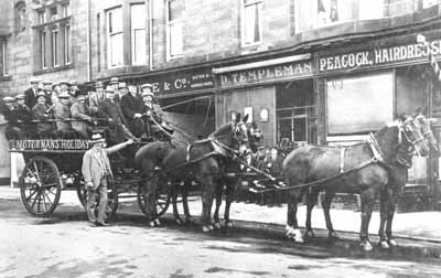 Motormen's Outing
Helensburgh motormen leaving for their annual trip from the Waldie & Co. motor and carriage hirers premises in Sinclair Street, circa 1917. Seeing off the party is John Hamilton of Waldies, and the carriage is being driven by Mr Reynolds, who often drove this carriage and was also the firm's undertaker.
