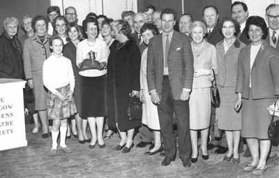 Theatre Arts Triumph
Mrs Vera McIntyre, producer of Helensburgh Theatre Arts Club's production of Lesley Storm's 'Roar Like A Dove', receives the Robert Dickson Memorial Trophy at a ceremony in the Citizens Theatre in Glasgow on May 1 1965. The winter production won the Scottish Community Drama Association's Dunbartonshire Three Act Play Festival, and some 40 members, including hon president Provost J.McLeod Williamson and his wife, went to see the presentation.
