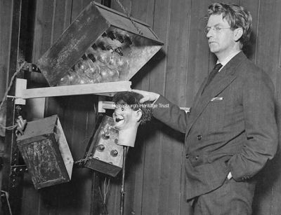 Stooky Bill
An October 3 1929 newspaper image of John Logie Baird with Stooky Bill, the dummy he used in his demonstrations, and TV equipment. The caption stated: "One more dream of science has been realised. Man's vision has spanned the Ocean, and transatlantic television has been demonstrated to be a reality. A man and a woman sat before an electric eye in a London laboratory last night, and a group of people in a darkened basement in the village of Hartsdale, New York, watched them turn their heads and move from side to side. The images were crude and broken, but they were images nevertheless."
