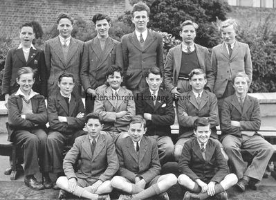 1943 Hermitage School class
Members of a class of 13 year-olds at Hermitage School in East Argyle Street pictured during the Second World War, including some evacuees from Clydebank. Back: Jim Arrol, John Osborne, unknown, unknown, Robert Dunlop, unknown; middle: unknown, Bobby Phillips, Ian Gilchrist, unknown, Jack Orr Winton, Roy McKenzie; front: unknown, Henry Brown, unknown. Image supplied by Bobby Phillips.

