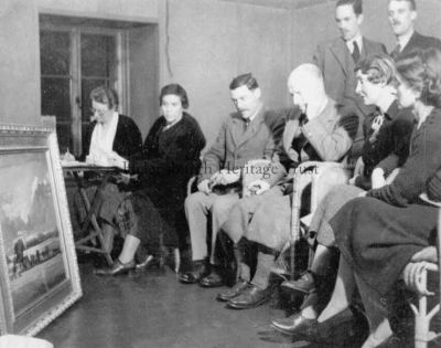 Art appraisal
The Helensburgh Art Exhibition committee appraise 'Lyleston Farm' by James Dunlop Burgess for what is thought to have been the second such exhibition, circa 1935/6. From left: Nance Anderson, unknown, Alistair Paterson, J.Arnold Fleming, unknown, Agnes Stevens. Standing are artists Gregor Ian Smith and James Dunlop Burgess. Image supplied by Jenny Sanders.

