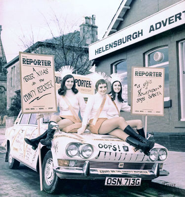 Advertiser promotion
Three members of the Helensburgh Advertiser staff sit on proprietor Craig M.Jeffrey's decorated Triumph 2000 car outside the then 17-19 East King Street office and printing plant before promoting the Advertiser and its sister weekly, the Dunbarton County Reporter, at the annual traders Christmas parade in Alexandria in the early 1970s. Centre is Carol Campbell, and on the right Alison Fraser.
