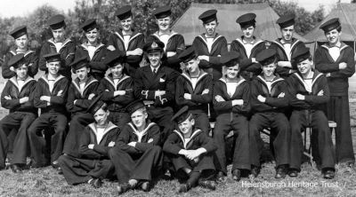 World War Two Sea Cadets
Helensburgh's Ajax Company of the Sea Cadet Corps pictured at their 1944 Summer Camp at Stanley Park, Blackpool. Back row: ?, William Hardy, Hugh Dawson, Ian McPhail, George Hood, William Fyfe, William Daly, ? Dewar, ?; middle: Alastair Clow, ? McKechnie, Jim Hosie, Thomas Dickson, Lieutenant McLean, William Paterson, Thomas Dawson, Robert Hailstones, ?; seated: Leslie Ward, Thomas Isbister, ?. Image supplied by Robert Hailstones.
