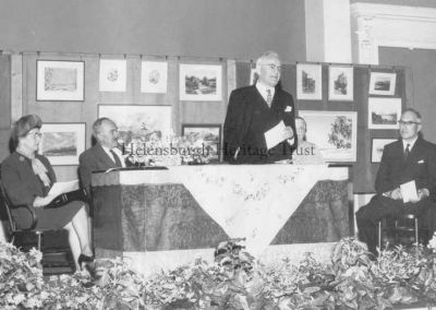 Art Show opening
The platform party at the opening of the Helensburgh Art Exhibition in the Pillar Hall, circa 1960. From left are Bailie Mrs Jae Gardiner, local artist Gregor Ian Smith, president of Helensburgh and District Art Club, Dr Tom Honeyman, director of Glasgow Art Galleries, Nance Anderson, and Mr Norman. Image supplied by Jenny Sanders.

