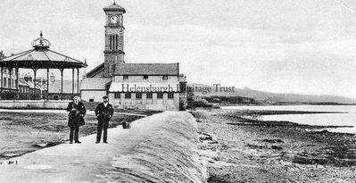 Bandstand and Granary
A view east from Helensburgh pier towards the old bandstand, the granary, and the Old Parish Church, circa 1908. The granary was a malt barn from the 1700s, and about 1900 part of it was converted into a garage. It became a restaurant in 1934 and was demolished in 1980. The church was built in 1847 and demolished in the 1980s.
