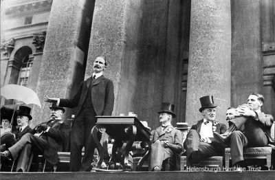 Working the crowd
Andrew Bonar Law makes a speech at an unknown location surrounded by dignitaries, circa 1920.
