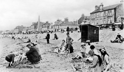 On the beach
A 1925 image of families relaxing, playing and building sandcastles on Helensburgh beach just to the west of the pier.
