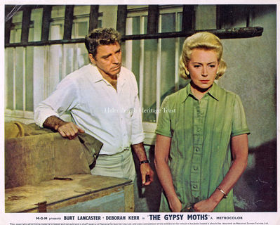 Burt Lancaster and Deborah Kerr
A Front of House Lobby Card featuring Burt Lancaster and Helensburgh film star Deborah Kerr in the MGM production of 'The Gypsy Moths'. A 1969 American film, directed by John Frankenheimer, it was based on the novel of the same name by James Drought. It is the story of three barnstorming skydivers and their effect on a midwestern American town. At the time, the sport of skydiving was in its infancy.
