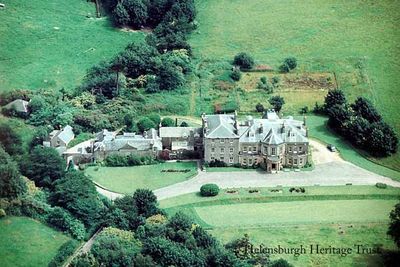 Camis Eskan House
An aerial view of Camis Eskan House, circa 1972, when it was in use as a hospital. The main part was built in 1648 by the Dennistouns, who had a royal connection through marriage. In 1836 the mansion was sold to Colin Campbell from Renfrewshire, and his descendants owned it until November 1946 when it was bought by the then Dunbartonshire County Council. Well known Helensburgh architect A.N.Paterson was commissioned by the then tenant, lawyer Leonard Gow, to modernise and extend the building in 1915. During the Second World War it was requisitioned by the Government and used as a hospital for Polish Army casualties, then rented to the County Council for use as a hospital for, first, TB patients, then infectious diseases, then maternity, and finally geriatric use. In 1979 it was developed for private flats and dwellings. Image supplied by Robert Reid.
