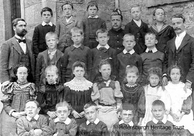 Cardross class?
A FORMER Helensburgh woman who now lives in Shetland is trying to find out more about her family history through this photograph. Cathy Shearer thinks that her mother told her that the photo was taken at Cardross School in the late 1890s. She believes that her grandfather, Robert Colquhoun, who was born at Auchensail Farm in 1884, is standing in the back row, second from the left. The photograph was taken and mounted by M.Pearlman & Co., of Glasgow, Paisley and Rothesay. If you have any more details please email the editor of this website.
