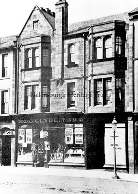 R.M.Clyde, Grocers
The R.M.Clyde grocery at 64 and 66 West Princes Street, Helensburgh. The red sandstone building was called Waverley Place, and was designed by Robert Wemyss and built in 1897, opposite the Post Office. Next door to the shop is the tearoom of McAdam the baker.
