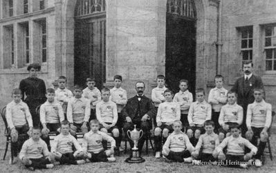 Clyde Street School team
An early team from Clyde Street School with a trophy, possibly the local primary schools football league or cup. The school opened in 1903. Anyone with more information is asked to contact the editor of the Trust website, using the Contact Us facility on the main website home page. Image date unknown.
