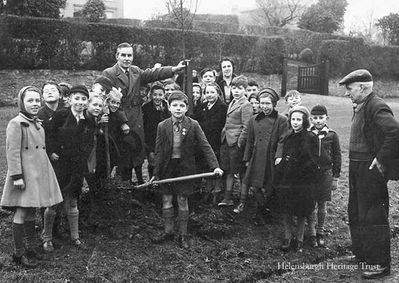 Coronation tree planting
Alex Douglas, headmaster of Clyde Street School, teacher Miss Laing, and some of their pupils plant a tree outside 27 East Montrose Street, Helensburgh, to mark the Coronation of Queen Elizabeth on June 2 1953. Image supplied by Alex Hunter, now of Ontario, Canada, who is the boy holding the shovel, and taken by Alexandria press photographer Peter Leddy.
