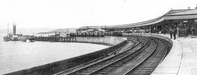Craigendoran Station pier platform
The platform at Craigendoran Station which brought trippers direct to the steamers at the pier, and one steamer can be seen. Both the station and the piers were built in 1882 after a plan to extend the Helensburgh line through the town centre to Helensburgh pier fell through because of local opposition. Image date unknown.
