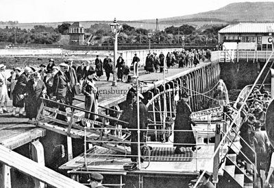 Craigendoran Pier
All aboard at Craigendoran Pier â€” passengers from the boat train board the steamer Marmion for a trip 'doon the watter', circa 1930. In the background is the now demolished Craigendoran signal box. Image supplied by Campbell Neil.
