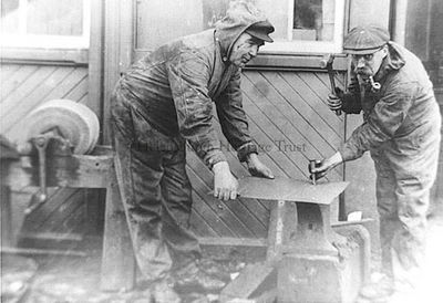 Hard at work
Two workmen at the North British Railway workshop at Craigendoran Station and Pier about 1910-1914. On the right is William Halford of Helensburgh.
